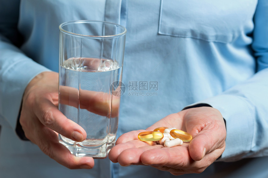女人手里拿着各种药丸欧米茄3黄胶囊氨基葡萄糖和钙膳食补充图片