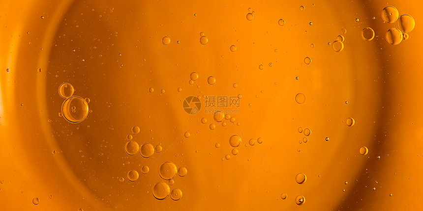 黄色和橙色的泡沫水中的油滴橄榄油图片