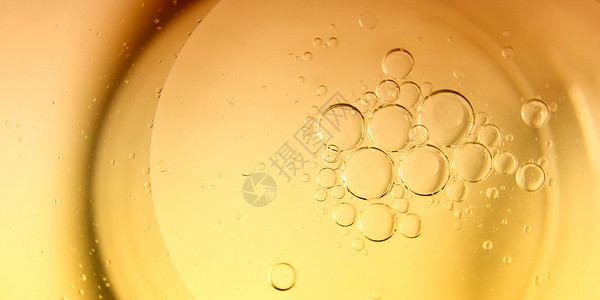 黄色背景烹饪油泡和水滴图片