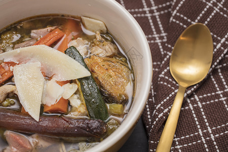 由苏奇尼胡萝卜肉类布鲁贝芽洋葱和鸡汤制成的多彩蔬菜汤碗图片