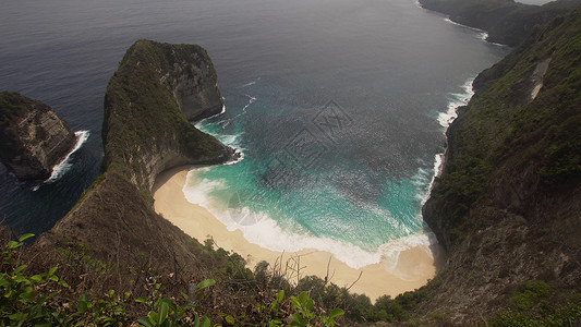 热带海滩在岩石悬崖之间图片