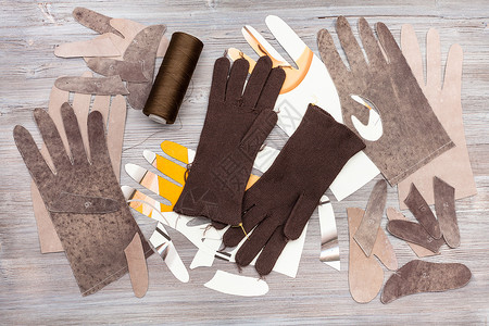 缝纫手套车间木制背景手套生产的各种物图片