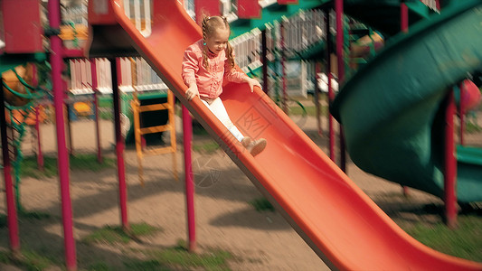 儿童滑落在公园的滑幻灯片上图片