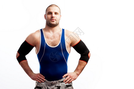 穿着蓝衬衫运动裤和手肘垫的年轻运动男摔跤手图片