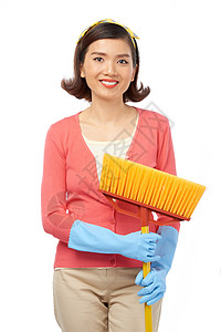 手拿着扫帚的亚裔妇女从扫地板上分心与图片