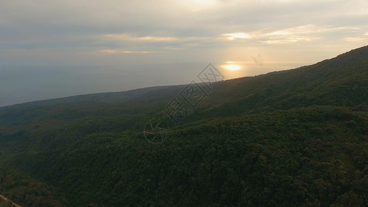 热带岛屿海洋山脉卡米金的日落图片