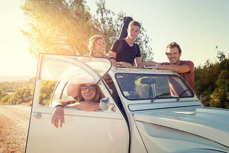 一群快乐的人在夏天的汽车附近图片