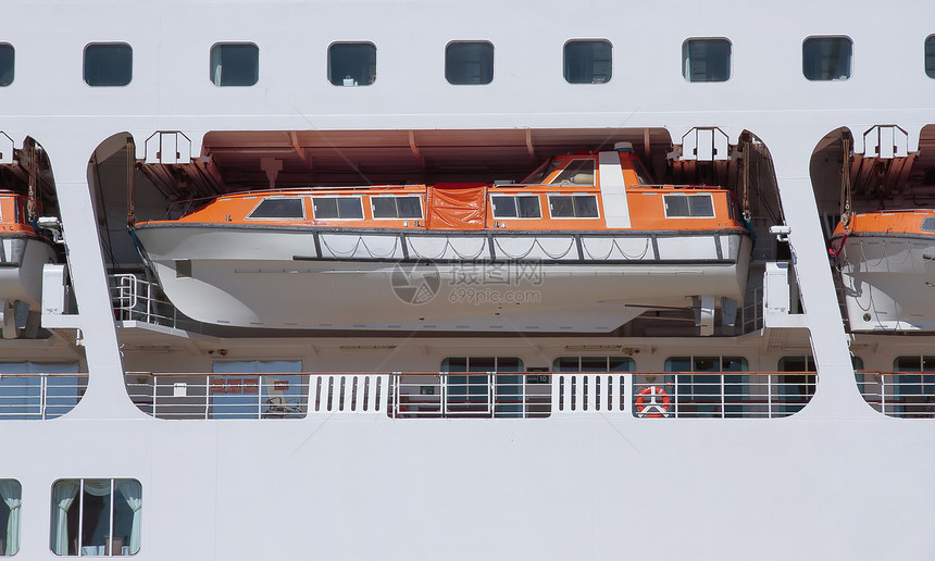 游轮甲板上橙色救生艇前景的图片