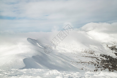 在山顶上观测雪覆盖的山峰图片
