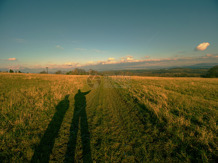 人类和儿子在草原黄色绿背景上的影子秋天的埃普蒂图片