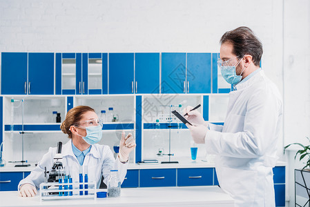 科学家在实验室用试剂和显微镜工作的白图片