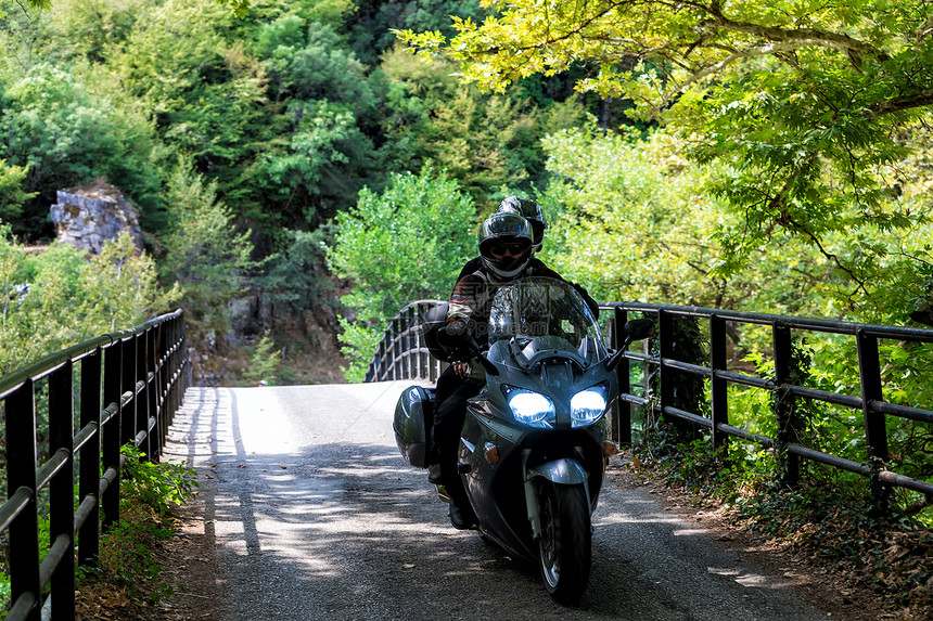 在希腊Zagorochoria的森林道路上骑着摩图片