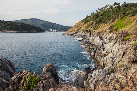 海浪冲向岩石海岸的悬崖图片