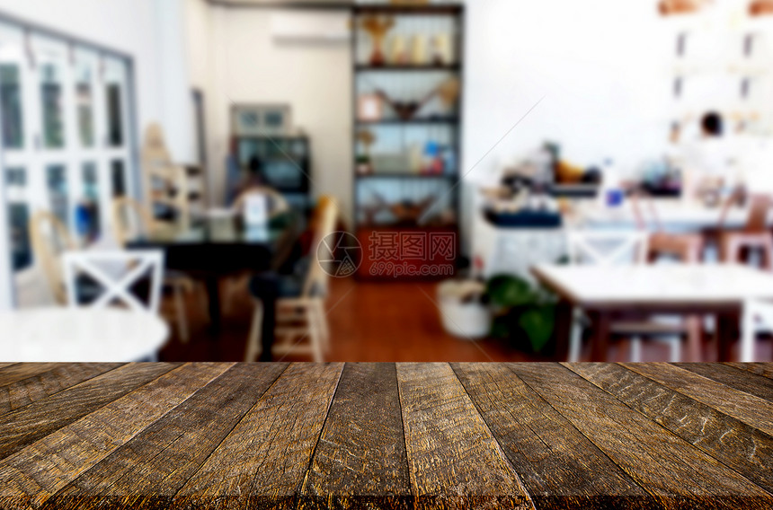 选中的空焦距棕色木制桌和咖啡店或餐馆背景模糊图片