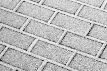 雪覆盖了铺设的瓷砖下雪后的板块冬季路图片
