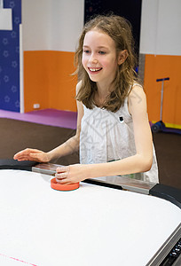 玩桌上曲棍球游戏的可爱小女孩图片