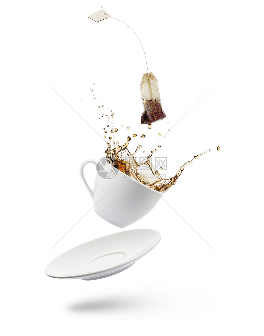 一杯茶落下茶包溅在白色背景上图片