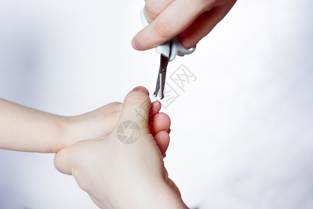 妈在女婴的手指上剪指甲图片