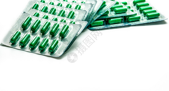 穿心莲提取物用于治疗普通感冒和喉咙痛标准化的草药胶囊丸白色背景上的一堆绿色胶囊丸背景图片