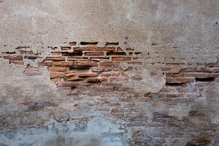 被碎裂和腐烂的砖块stucco墙壁纹理背景很久图片