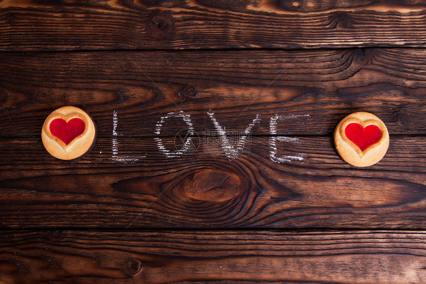 用粉笔在木桌上和饼干上写的爱字图片