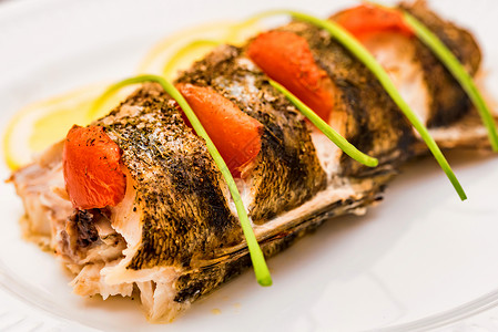 用梭子鱼片柠檬番茄和芦笋封闭盘子健康饮食概念图片
