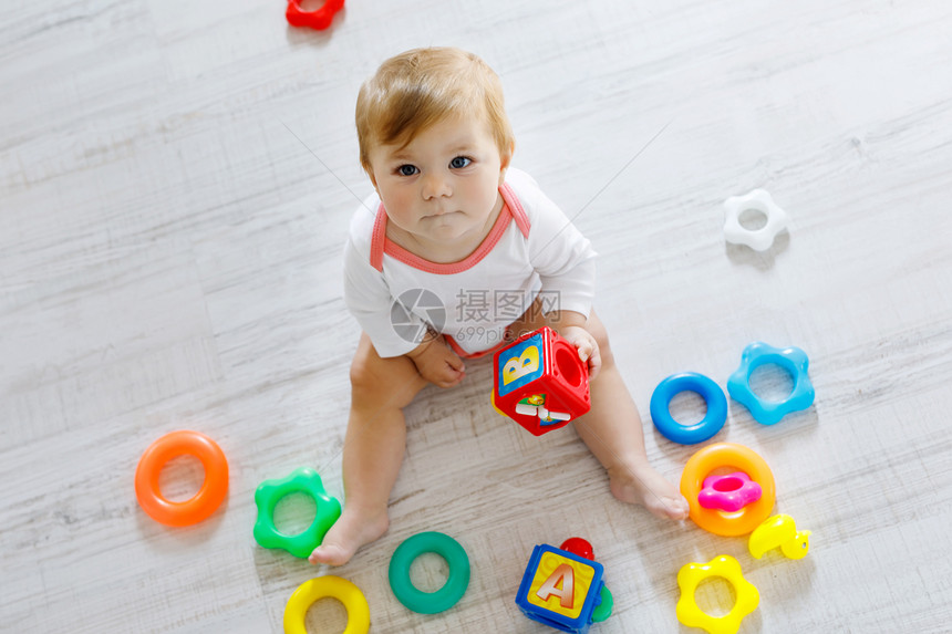可爱的女婴在幼儿园玩益智玩具快乐健康的孩子在家里玩五颜六图片