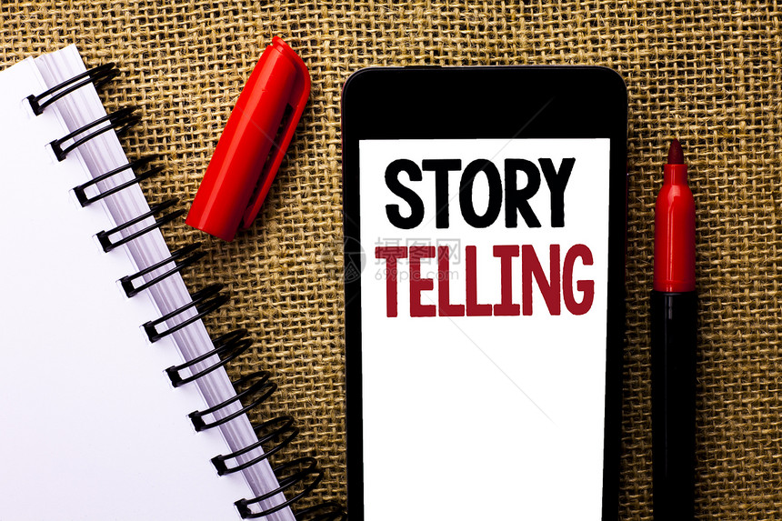 手写文本讲故事概念意思是讲或写短篇故事分享个人经历写手机黄麻背景标记和图片