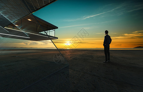 商人用现代建筑背景的钢铁和玻璃外表仔细地看日出S图片