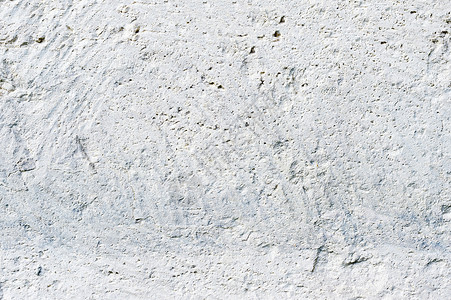 建筑物外墙上的白漆多孔石的深层纹理墙壁背景图片