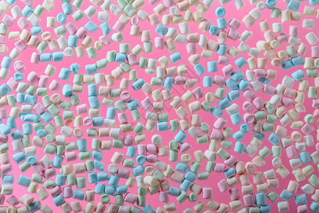 粉红色背景上的棉花糖彩色迷你棉花糖的背景或图片