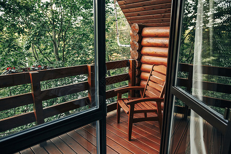 树林间小屋门廊上的木椅山寨的阳台上可以看到山中的森林大气的时刻暑假图片