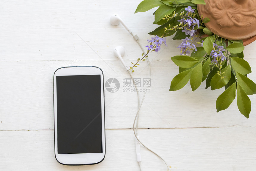 带耳机的手机背景为白色的花朵图片