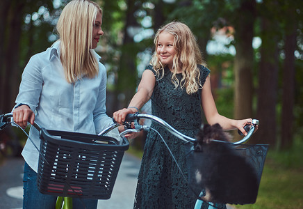 一个母亲和女儿的肖像带着金发骑自行车骑着自行车还有他们可爱的图片