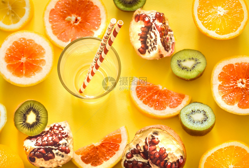 各种水果的玫瑰花环和黄色背景上带吸管的玻璃杯健康食品和新鲜食品图片