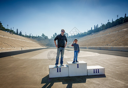 父亲和儿子站在Panathinaiko体育场赢家的讲台上图片
