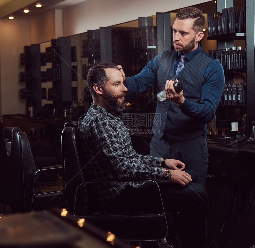 专业理发师在美发沙龙与客户合作理发图片