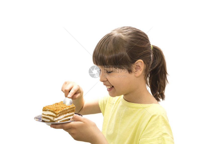 女孩吃蛋糕在白色背景上被隔离图片