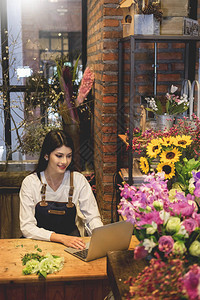 寻找花女的笔记本电脑在花店柜台订了菜图片