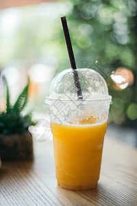 木桌上的橙汁冰沙玻璃图片