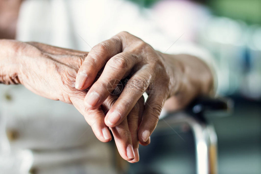 关闭患有帕金森病症状的老年妇女患者的手和图片