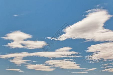 蓝色夏日天空中异常形状的小蓬松云图片