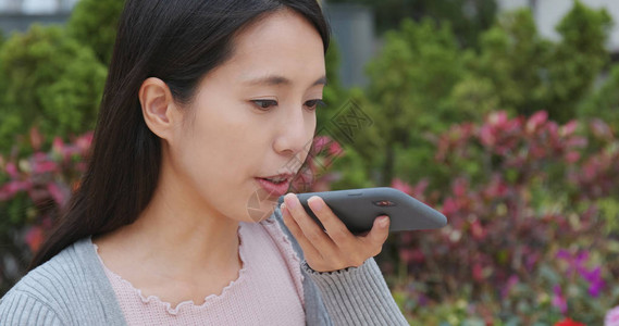 女人在手机上发送音频消息图片