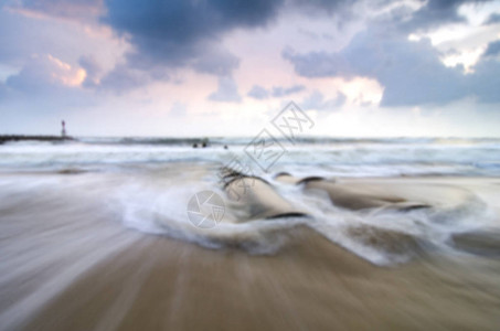 沙滩上惊人日出景色的模糊图像软波撞上背景图片