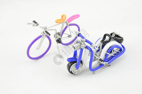 用白色背景隔离的彩色铁丝线制作的手工制作纪念品摩托车和自行车选图片