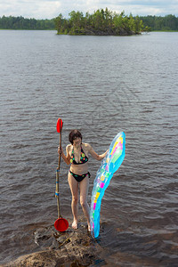 湖上带气垫和桨的女人图片