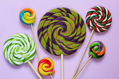 在柔和的背景的五颜六色的棒糖流行糖果图片