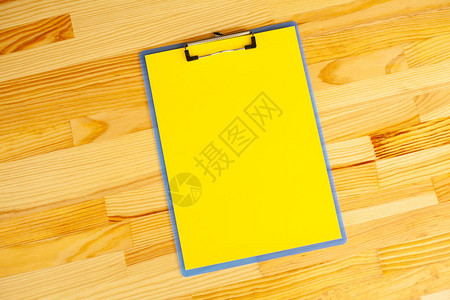 与黄纸的空白文件夹手拿着文件夹和木背景上的句柄复制空间图片