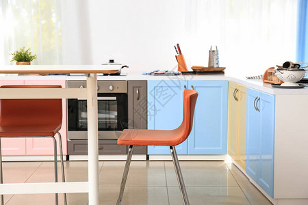 明亮的现代厨房内部配有桌子和椅子图片