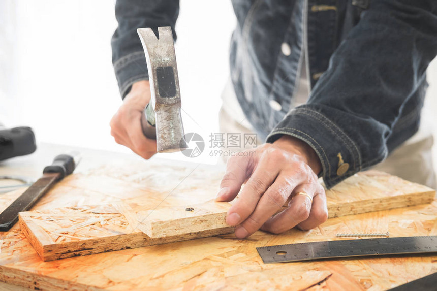 木匠仔细查看木工作的计划他是工作场所的成功企业家用刀具在建筑工地图片